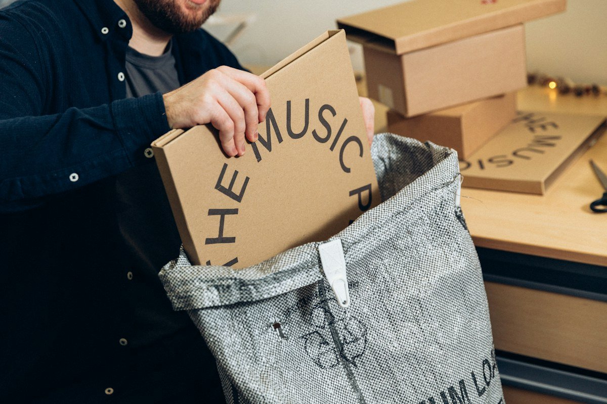 A small business owner preparing a cardboard parcel