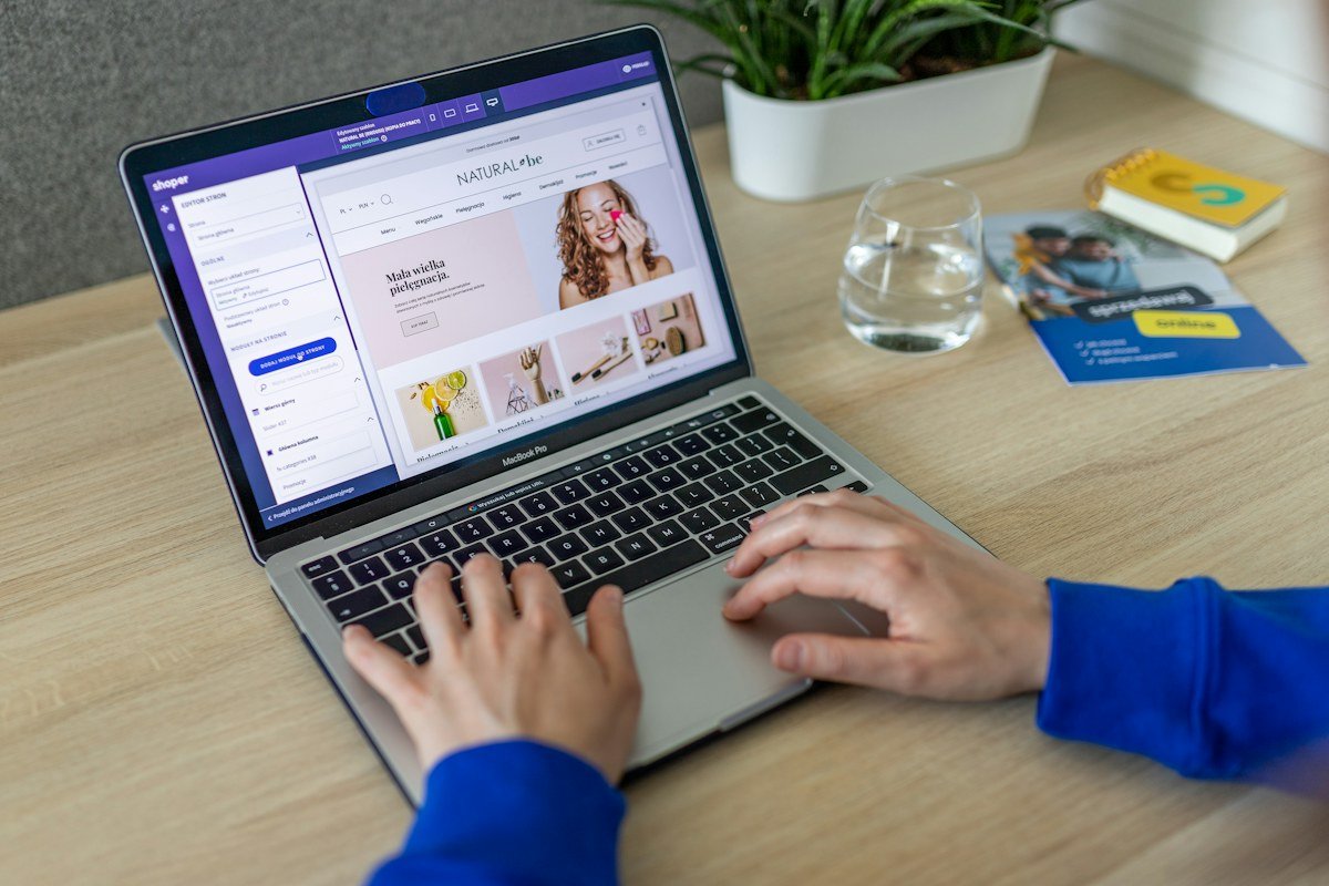 Hands working on an online store at a laptop