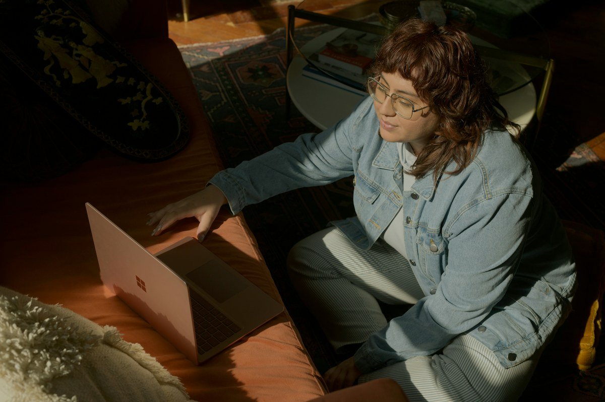 A woman using her laptop at a table for remote work