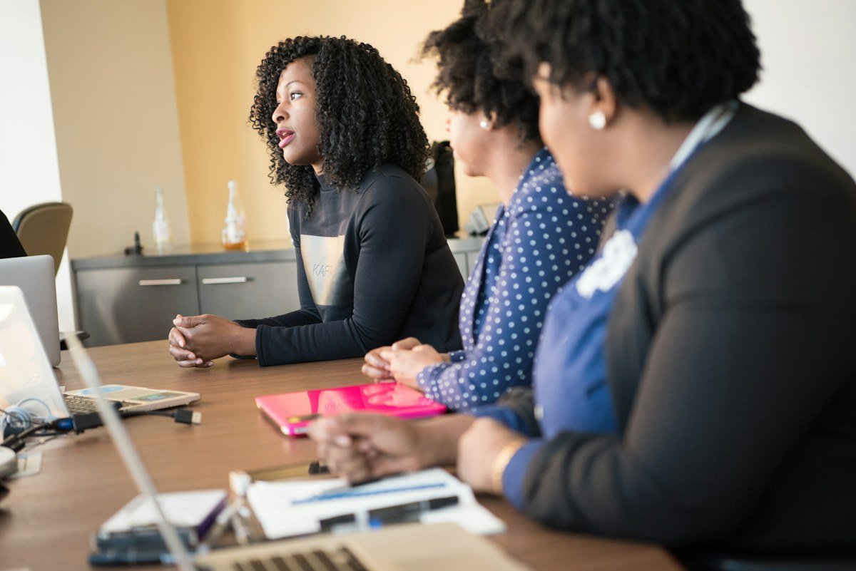 Colleagues discussing work together at a table